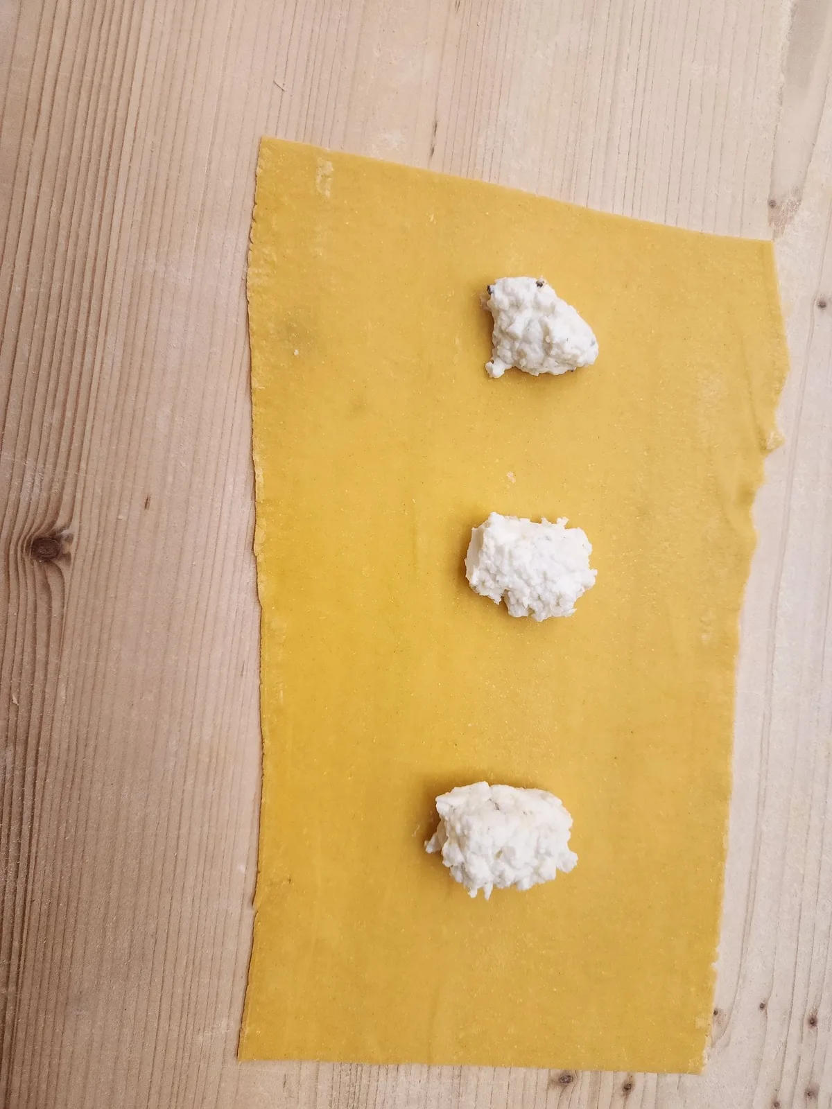 Close view of handmade ravioli on a floured work surface